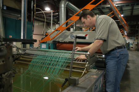 Worker tending the rope twisting line at Polysteel
